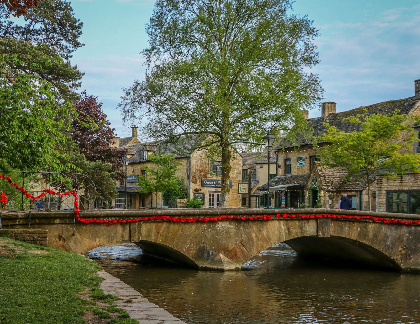A stone bridge over the river in a Cotswold village